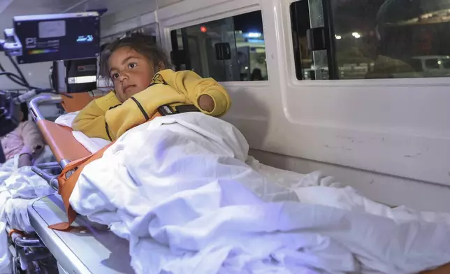 A Palestinian girl injured in the Israeli military's ground and air offensive on Gaza, sits in an ambulance as the first group of sick Gaza children arrives in Jordan for medical treatment at the King Hussein Bridge border crossing on Tuesday, March 4, 2025. (AP Photo/Raad Adayleh)