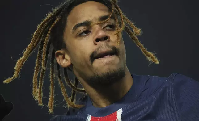 PSG's Bradley Barcola celebrates scoring his side first goal during the French League One soccer match between Paris Saint-Germain and Lille, Saturday, March 1, 2025 at the Parc des Princes stadium in Paris. (AP Photo/Christophe Ena)
