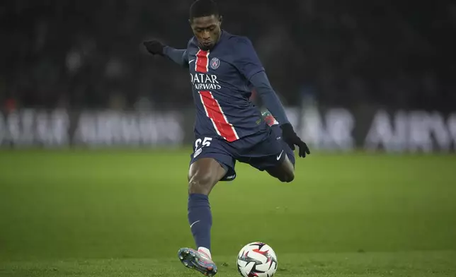 PSG's Nuno Mendes kicks the ball during the French League One soccer match between Paris Saint-Germain and Lille, Saturday, March 1, 2025 at the Parc des Princes stadium in Paris. (AP Photo/Christophe Ena)