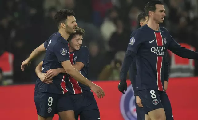 PSG's Goncalo Ramos, left, PSG's Joao Neves, center, and PSG's Fabian Ruiz react during the French League One soccer match between Paris Saint-Germain and Lille, Saturday, March 1, 2025 at the Parc des Princes stadium in Paris. (AP Photo/Christophe Ena)