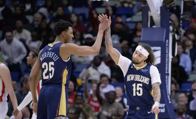 New Orleans Pelicans guards Trey Murphy III (25) and Jose Alvarado (15) celebrate during the first half of an NBA basketball game against the Houston Rockets in New Orleans, Thursday, March 6, 2025. (AP Photo/Matthew Hinton)