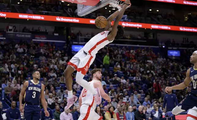 Houston Rockets forward Amen Thompson (1) dunks against the New Orleans Pelicans during the first half of an NBA basketball game in New Orleans, Thursday, March 6, 2025. (AP Photo/Matthew Hinton)