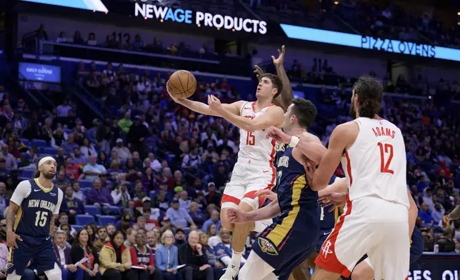 Houston Rockets guard Reed Sheppard (15) shoots against the New Orleans Pelicans during the first half of an NBA basketball game in New Orleans, Thursday, March 6, 2025. (AP Photo/Matthew Hinton)