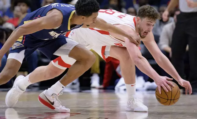 Houston Rockets center Alperen Sengun (28) steals the ball from New Orleans Pelicans guard Trey Murphy III (25) during the first half of an NBA basketball game in New Orleans, Thursday, March 6, 2025. (AP Photo/Matthew Hinton)
