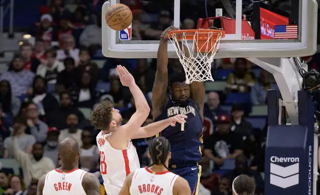 New Orleans Pelicans forward Zion Williamson (1) gets fouled with attempting a dunk against Houston Rockets center Alperen Sengun (28) during the first half of an NBA basketball game in New Orleans, Thursday, March 6, 2025. (AP Photo/Matthew Hinton)
