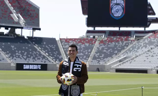 FILE - Hirving "Chucky" Lozano poses with a San Diego FC scarf during an introductory news conference for the new MLS soccer team Thursday, June 13, 2024, in San Diego.  (AP Photo/Gregory Bull, FIle)
