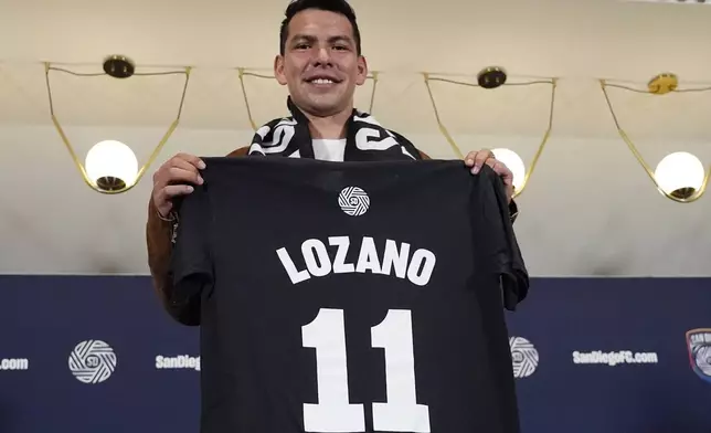 FILE - Hirving "Chucky" Lozano poses with his new San Diego FC jersey during an introductory news conference for the new MLS soccer team Thursday, June 13, 2024, in San Diego. (AP Photo/Gregory Bull, File)