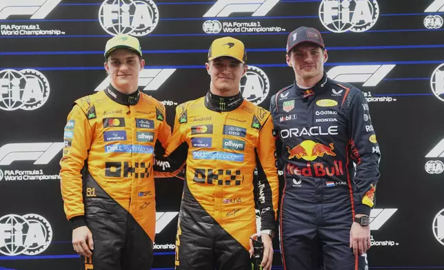 McLaren driver Lando Norris, centre of Britain poses after taking pole position with second placed teammate Oscar Piastri, left, of Australia and third placed Red Bull driver Max Verstappen of the Netherlands at the Australian Formula One Grand Prix at Albert Park, in Melbourne, Australia, Saturday, March 15, 2025. (AP Photo/Scott Barbour)