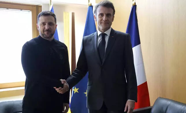 Ukraine's President Volodymyr Zelenskyy, left, meets French President Emmanuel Macron on the sidelines of the European Council to discuss continued support for Ukraine and European defense, in Brussels, Thursday, March 6, 2025. (Ludovic Marin, Pool via AP)