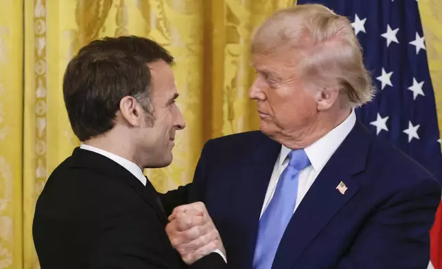 President Donald Trump, right, shakes the hand of France's President Emmanuel Macron during a joint press conference in the East Room of the White House in Washington, Monday, Feb. 24, 2025. (Ludovic Marin/Pool via AP)