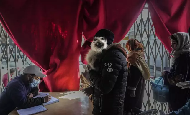 People register their pet cats for treatment at Kashmir veterinary hospital in Srinagar, Indian controlled Kashmir, Friday, Feb. 7, 2025 (AP Photo/Mukhtar Khan)