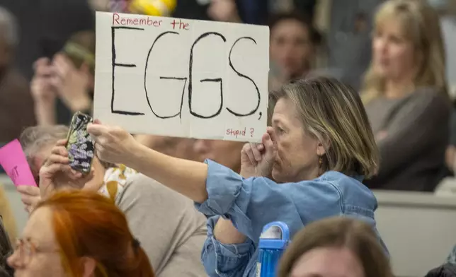 A participant holds a sign during a GOP town hall meeting with Reps. Celeste Maloy and Mike Kennedy, R-Utah, Thursday, March 20, 2025, in Salt Lake City. (AP Photo/Rick Egan)