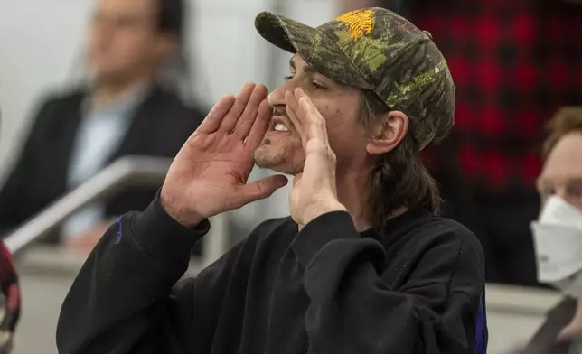 Owen Brings shouts a question to Reps. Celeste Maloy and Mike Kennedy, R-Utah, during a GOP town hall meeting Thursday, March 20, 2025, in Salt Lake City. (AP Photo/Rick Egan)