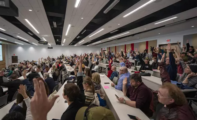 Concerned citizens raise their hands during a GOP town hall meeting with Reps. Celeste Malloy and Mike Kennedy, R-Utah, Thursday, March 20, 2025, in Salt Lake City. (AP Photo/Rick Egan)