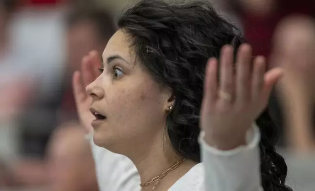 Megan Allen listens to Reps. Celeste Maloy and Mike Kennedy, R-Utah, during a GOP town hall meeting Thursday, March 20, 2025, in Salt Lake City. (AP Photo/Rick Egan)