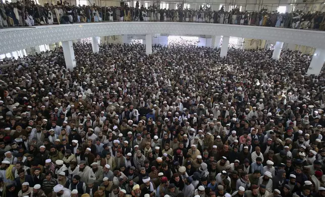 Mourners attend the funeral prayer of a senior Muslim cleric, Hamidul Haq who was killed in the Friday's suicide bomb attack, at a pro-Taliban seminary in Akora Khattak, Pakistan, Saturday, March 1, 2025. (AP Photo/Muhammad Sajjad)