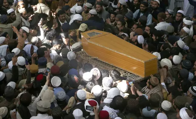 Mourners carry the casket of a senior Muslim cleric, Hamidul Haq who was killed in the Friday's suicide bomb attack at a pro-Taliban seminary, during a funeral prayer in Akora Khattak, Pakistan, Saturday, March 1, 2025. (AP Photo/Muhammad Sajjad)