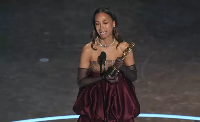 Zoe Saldana accepts the award for best performance by an actress in a supporting role for "Emilia Perez during the Oscars on Sunday, March 2, 2025, at the Dolby Theatre in Los Angeles. (AP Photo/Chris Pizzello)