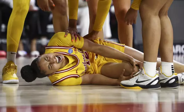 Southern California guard JuJu Watkins (12) reacts on the floor after an injury during the first half against Mississippi State in the second round of the NCAA college basketball tournament Monday, March 24, 2025, in Los Angeles. (AP Photo/Jessie Alcheh)