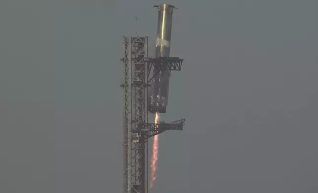 The booster of SpaceX's mega rocket Starship is recaptured during a test flight from Starbase in Boca Chica, Texas, Thursday, March 6, 2025. (AP Photo/Eric Gay)