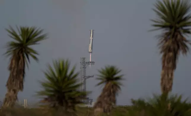 The booster of SpaceX's mega rocket Starship is recaptured during a test flight from Starbase in Boca Chica, Texas, Thursday, March 6, 2025. (AP Photo/Eric Gay)