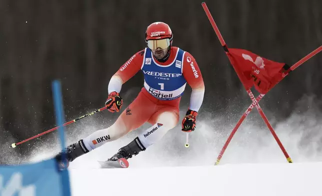 Switzerland's Loic Meillard competes in an alpine ski, men's World Cup Giant Slalom, in Hafjell, Norway, Saturday, March 15, 2025. (AP Photo/Gabriele Facciotti)
