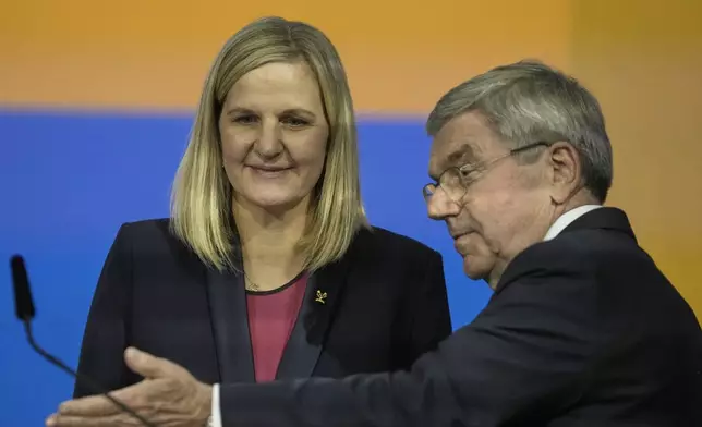 IOC President Thomas Bach, right, gestures to Kirsty Coventry after she was announced as the new IOC President at the International Olympic Committee 144th session in Costa Navarino, western Greece, Thursday, March 20, 2025. (AP Photo/Thanassis Stavrakis)