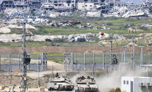 Israeli tanks maneuver on the border with northern Gaza Strip as seen from southern Israel, Tuesday, March 18, 2025. (AP Photo/Ohad Zwigenberg)