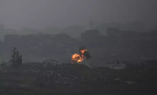 An explosion erupts in the northern Gaza Strip, as seee from southern Israel, on Tuesday, March 18, 2025. (AP Photo/Leo Correa)
