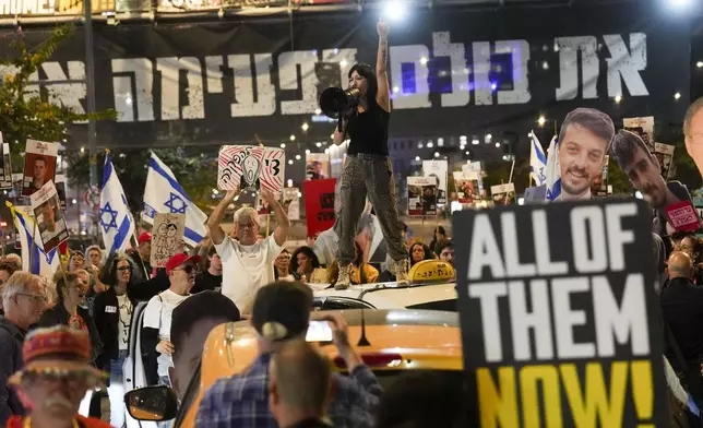 Protesters demand the release of hostages held in the Gaza Strip, in Tel Aviv, Israel, Tuesday, March 18, 2025. (AP Photo/Ariel Schalit)