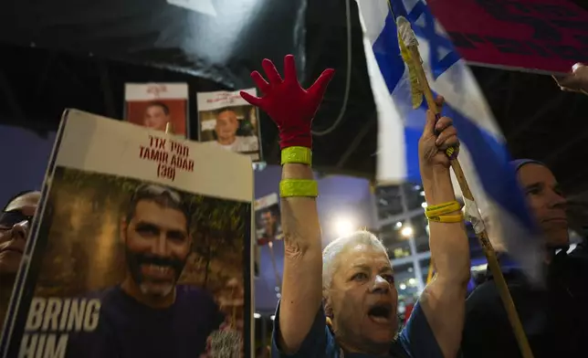 Protesters demand the release of hostages held in the Gaza Strip, in Tel Aviv, Israel, Tuesday, March 18, 2025. (AP Photo/Ariel Schalit)