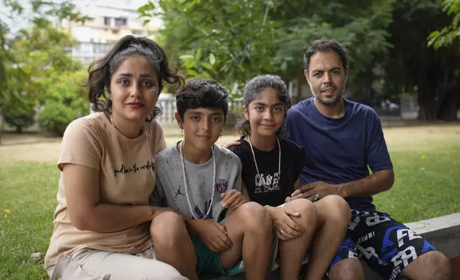Ebrahim Ghezelgechi, right, a migrant from Iran, poses for a portrait with his wife Sahar Bideman and their children Sam and Aylin in Panama City, Monday, March 10, 2025, after they were deported from the U.S., detained for weeks in a Panamanian immigration camp, and released on a temporary humanitarian visa allowing a 30‑day stay. (AP Photo/Matias Delacroix)