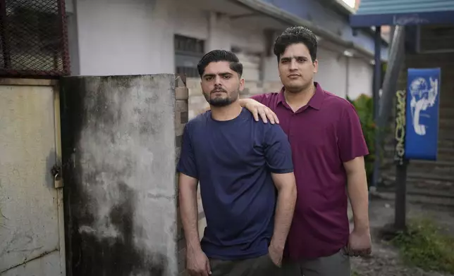 Samin Haider, left, a migrant from Pakistan, and his cousin Saqlain Sayed, pose for a portrait in Panama City, Monday, March 10, 2025, after being deported from the United States, detained for weeks in a Panamanian immigration camp, and released on a temporary humanitarian visa allowing a 30‑day stay. (AP Photo/Matias Delacroix)