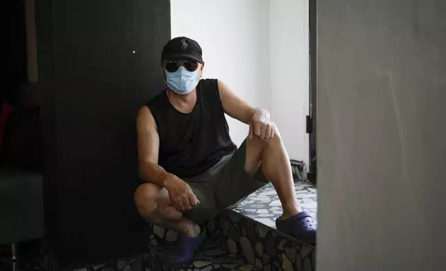 Wang Qiu, a migrant from China, poses for a portrait in Panama City, Tuesday, March 11, 2025, after being deported from the United States, detained for weeks in a Panamanian immigration camp, and released on a temporary humanitarian visa allowing a 30‑day stay. (AP Photo/Matias Delacroix)