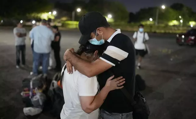 Migrants who were held in a Panamanian immigration shelter after being deported from the U.S. embraced upon arriving in Panama City on Saturday, March 8, 2025, after authorities gave them 30 days to leave the country. (AP Photo/Matias Delacroix)