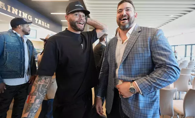 Dallas Cowboys quarterback Dak Prescott, left, and lineman Zach Martin share a laugh after Martin announced his retirement during an NFL football press conference at the team's headquarter in Frisco, Texas, Wednesday, March 5, 2025. (AP Photo/LM Otero)