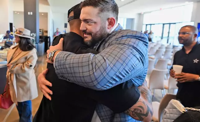 Dallas Cowboys quarterback Dak Prescott, left, hugs lineman Zach Martin after Martin announced his retirement during an NFL football press conference at the team's headquarter in Frisco, Texas, Wednesday, March 5, 2025. (AP Photo/LM Otero)