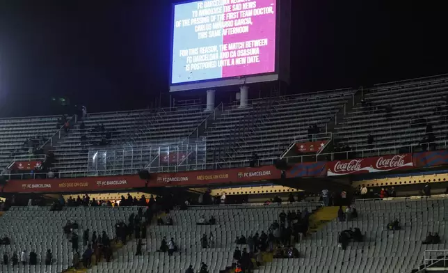 The screen with information that the Spanish La Liga soccer match between Barcelona and Osasuna is cancelled, at the Lluis Companys Olympic Stadium, in Barcelona, Spain, Saturday, March 8, 2025. (AP Photo/Joan Monfort)