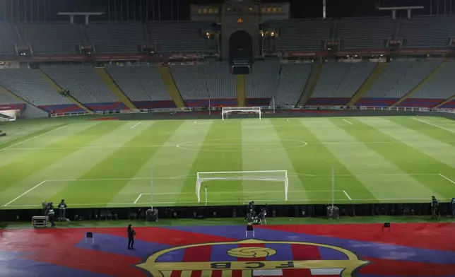 Empty stands and field seen after the cancellation of the Spanish La Liga soccer match between Barcelona and Osasuna, at the Lluis Companys Olympic Stadium, in Barcelona, Spain, Saturday, March 8, 2025. (AP Photo/Joan Monfort)
