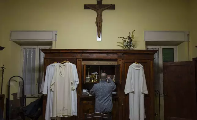 Priest Andrea Conocchia in the sacristy of the Beata Vergine Immacolata parish church in Torvaianica, Italy, Thursday, Feb. 27, 2025. (AP Photo/Bernat Armangue)