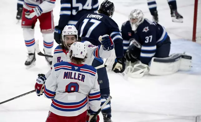 New York Rangers' Mika Zibanejad (93) celebrates his goal against the Winnipeg Jets with J.T. Miller (8) during the first period of an NHL hockey game in Winnipeg, Manitoba, Tuesday March 11, 2025. (Fred Greenslade/The Canadian Press via AP)