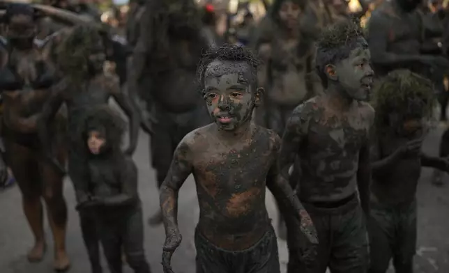 Young revelers attend the Mud Block carnival party in Paraty, Brazil, Saturday, March 1, 2025. (AP Photo/Andre Penner)