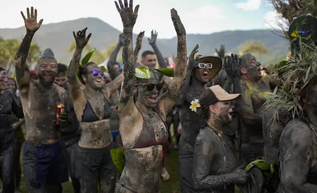 Revelers attend the Mud Block carnival party in Paraty, Brazil, Saturday, March 1, 2025. (AP Photo/Andre Penner)
