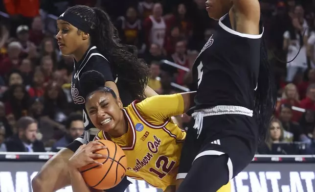 Southern California guard JuJu Watkins (12) draws a foul against Mississippi State guard Eniya Russell, left, and guard Chandler Prater (5) during the first half in the second round of the NCAA college basketball tournament Monday, March 24, 2025, in Los Angeles. (AP Photo/Jessie Alcheh)