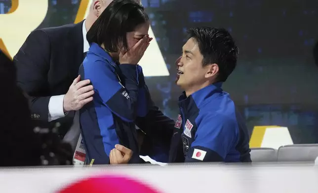 Riku Miura and Ryuichi Kihara, of Japan, react after the pairs free skating program at the figure skating world championships, Thursday, March 27, 2025, in Boston. (AP Photo/Charles Krupa)