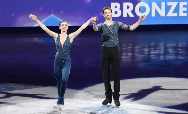 Sara Conti and Niccolo Macii, of Italy, acknowledge the audience after the pairs free skating program at the figure skating world championships, Thursday, March 27, 2025, in Boston. (AP Photo/Charles Krupa)