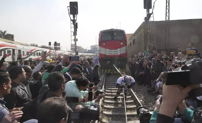 Egyptian wrestler Ashraf Mahrous, better known as Kabonga, pulls a train for nearly 10 meters, 33 feet, at Ramses Station in Cairo, Egypt, as he is watched by Guinness World Record observers, Thursday, March 13, 2025. (AP Photo/Amr Nabil) ID:
