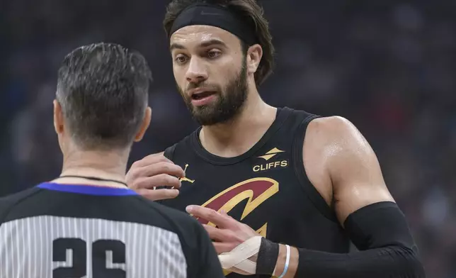 Cleveland Cavaliers guard Max Strus (1) discusses an official's call with referee Pat Fraher during the second half of an NBA basketball game against the Sacramento Kings in Sacramento, Calif., Wednesday, March 19, 2025. (AP Photo/Randall Benton)