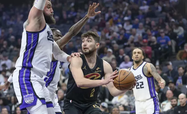 Cleveland Cavaliers guard Ty Jerome (2) is guarded by Sacramento Kings center Jonas Valanciunas, left, during the second half of an NBA basketball game in Sacramento, Calif., Wednesday, March 19, 2025. (AP Photo/Randall Benton)