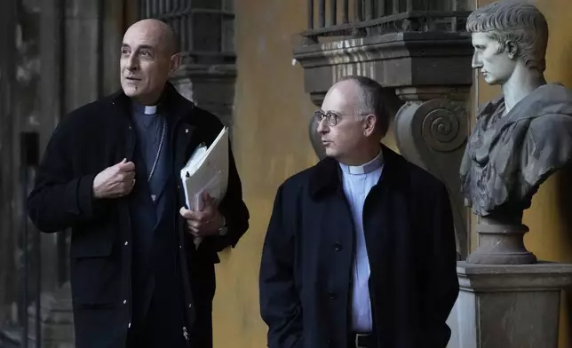 From left, Cardinal Victor Fernandez and Jesuit Father Antonio Spadaro arrive on the occasion of the presentation of a book by Pope Francis titled "Viva la Poesia" (long live poetry) in Rome, Friday, March 21, 2025. (AP Photo/Gregorio Borgia)
